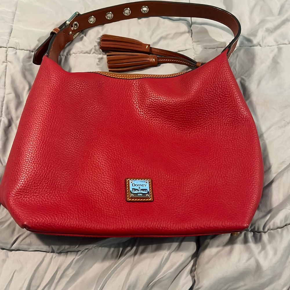 Pebble leather red Dooney and Bourke handbag.